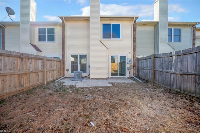 rear view of house with a patio and central AC