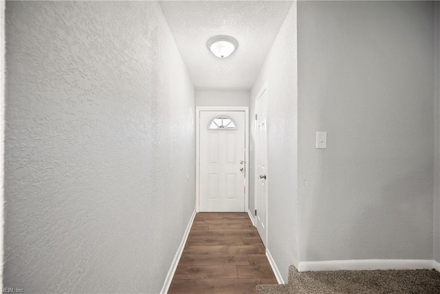 entryway featuring dark hardwood / wood-style flooring and a textured ceiling