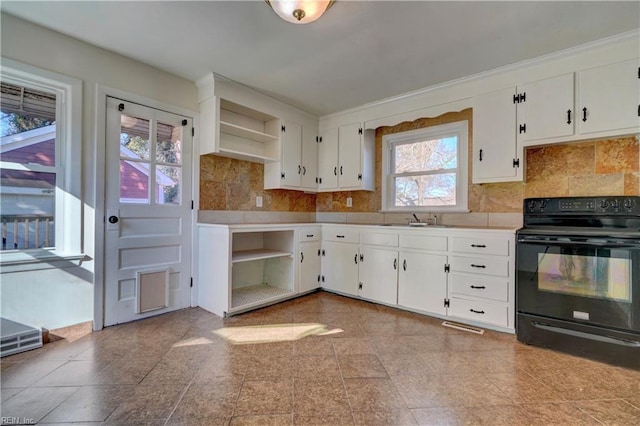 kitchen with black electric range, white cabinetry, a healthy amount of sunlight, and sink