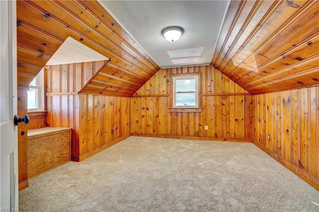 bonus room with wood walls, light colored carpet, wood ceiling, and vaulted ceiling