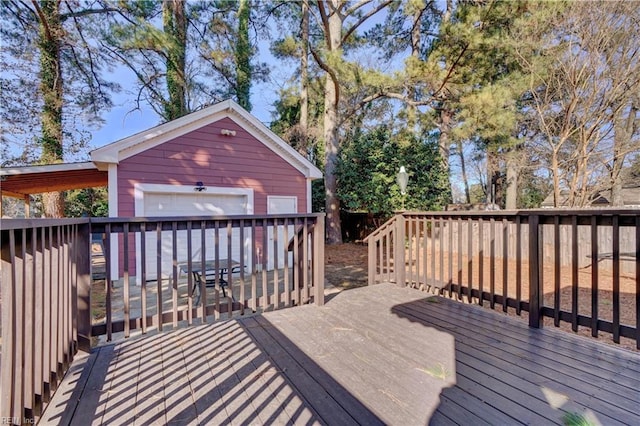 deck with a garage and an outdoor structure