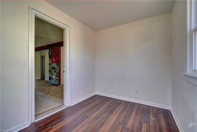 unfurnished room with dark wood-type flooring