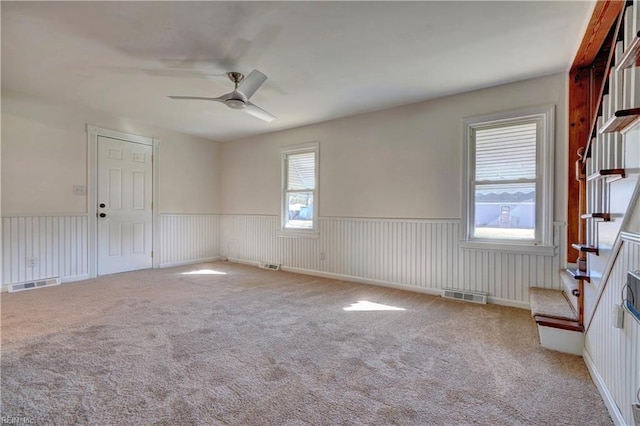 spare room featuring ceiling fan and carpet floors