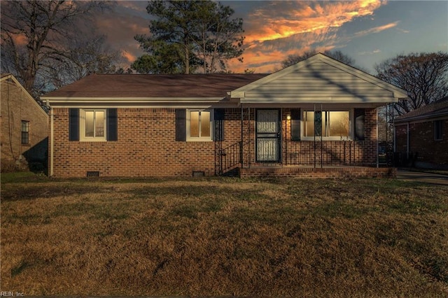 view of front of home with a porch and a yard