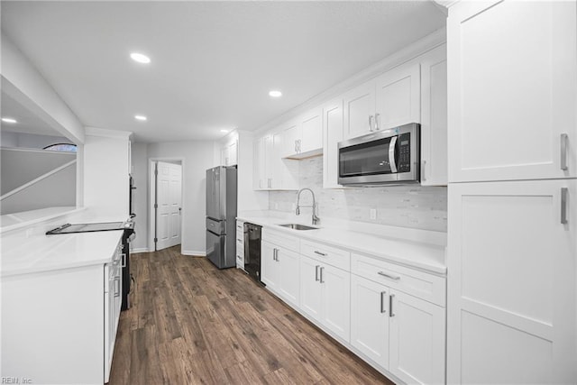 kitchen featuring backsplash, stainless steel appliances, sink, white cabinets, and dark hardwood / wood-style floors