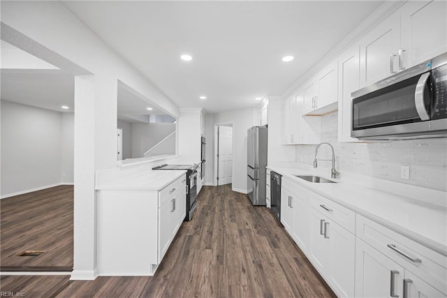 kitchen with tasteful backsplash, black appliances, sink, dark hardwood / wood-style floors, and white cabinetry