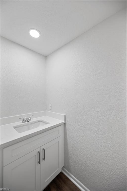 bathroom with hardwood / wood-style floors and vanity