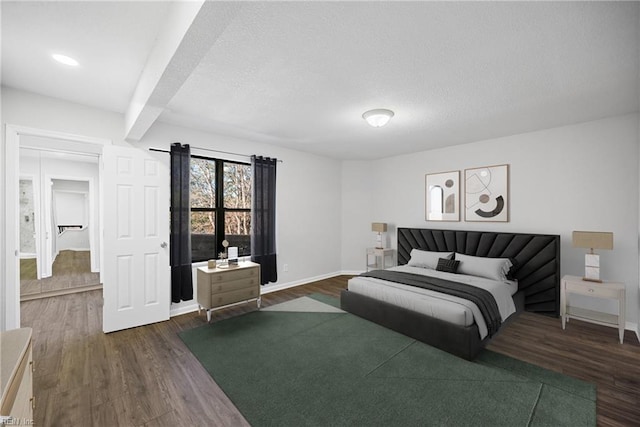 bedroom featuring beam ceiling and dark wood-type flooring