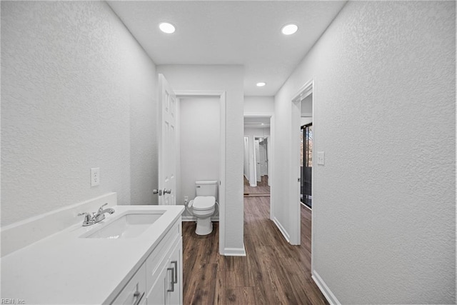 bathroom featuring hardwood / wood-style floors, vanity, and toilet