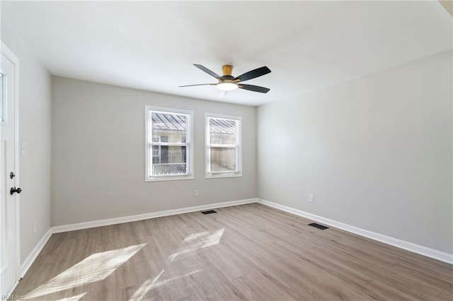 spare room featuring light hardwood / wood-style floors and ceiling fan