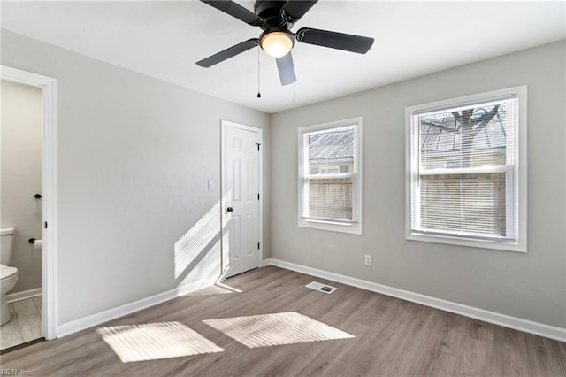 unfurnished room with ceiling fan and light hardwood / wood-style floors