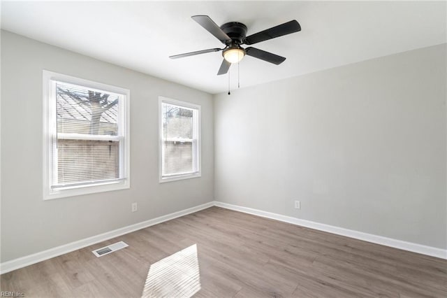 unfurnished room with light wood-type flooring and ceiling fan