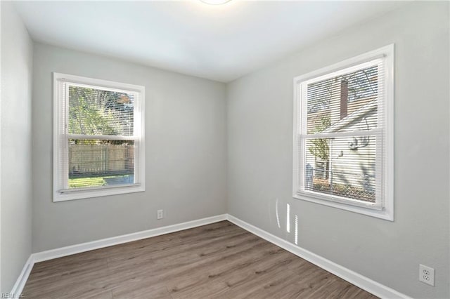 spare room featuring hardwood / wood-style flooring