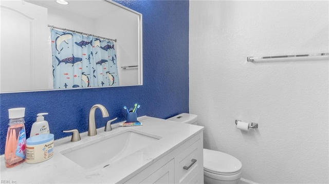 bathroom featuring a shower with shower curtain, vanity, and toilet