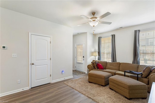 living room featuring hardwood / wood-style flooring and ceiling fan