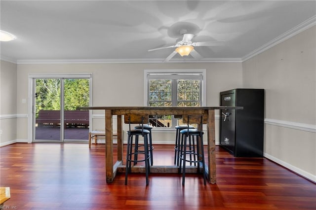 dining area featuring dark hardwood / wood-style flooring, plenty of natural light, and ornamental molding