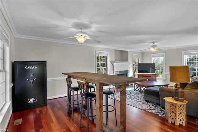 dining room featuring dark hardwood / wood-style flooring and crown molding