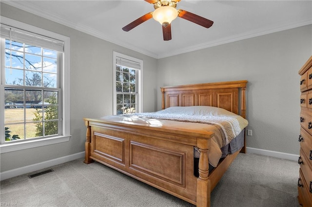 bedroom with ceiling fan, crown molding, and light carpet