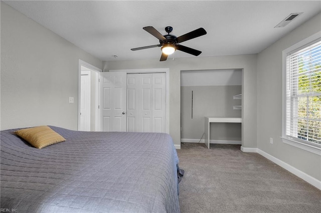 bedroom featuring ceiling fan, light colored carpet, and a closet