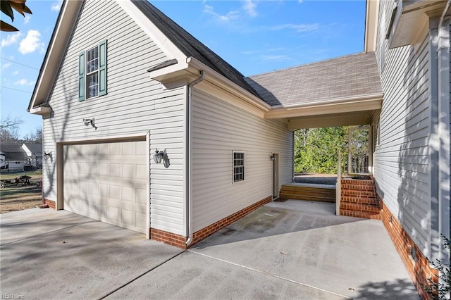 view of side of home featuring a garage