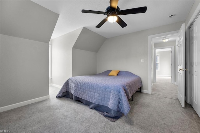 carpeted bedroom featuring vaulted ceiling and ceiling fan