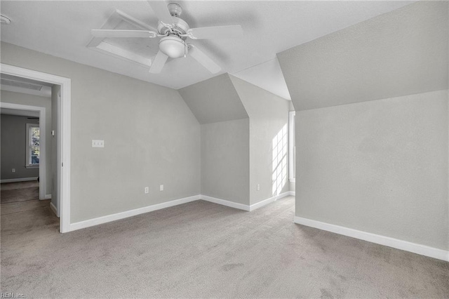 bonus room featuring light carpet, ceiling fan, and lofted ceiling