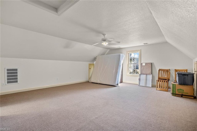 bonus room with a textured ceiling, carpet floors, ceiling fan, and lofted ceiling