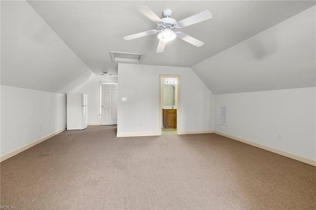 additional living space featuring carpet, ceiling fan, and vaulted ceiling