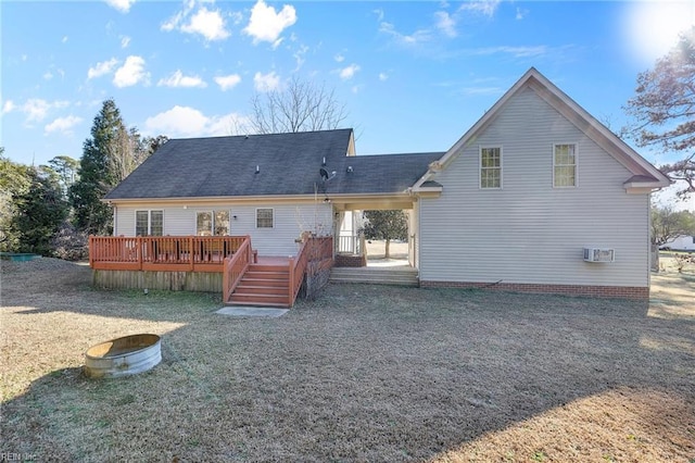 rear view of house with a lawn and a wooden deck