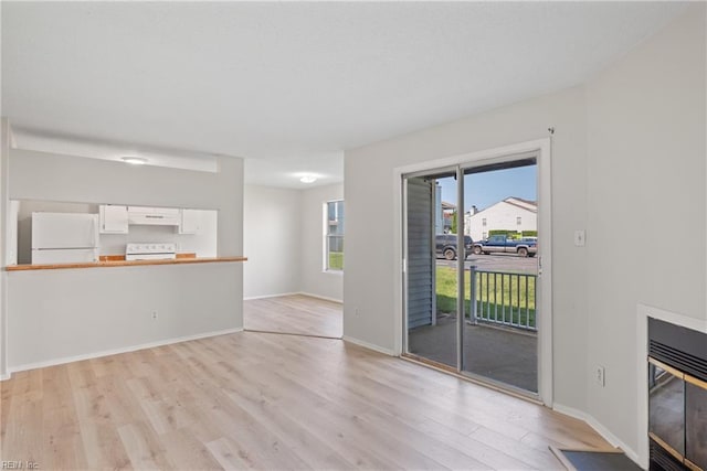 unfurnished living room with light hardwood / wood-style floors