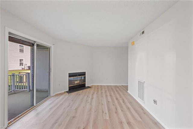 unfurnished living room with light hardwood / wood-style floors