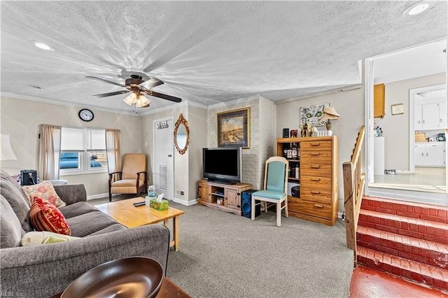 living room featuring ceiling fan, carpet floors, a textured ceiling, and ornamental molding