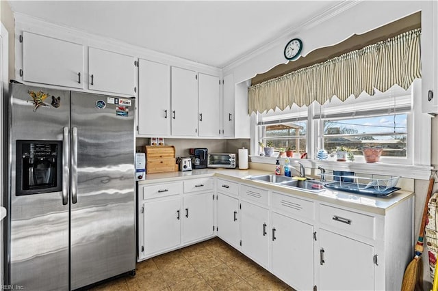 kitchen featuring crown molding, sink, white cabinets, and stainless steel refrigerator with ice dispenser