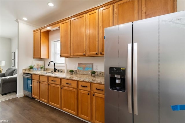 kitchen featuring sink, stainless steel appliances, light stone counters, dark hardwood / wood-style flooring, and ornamental molding