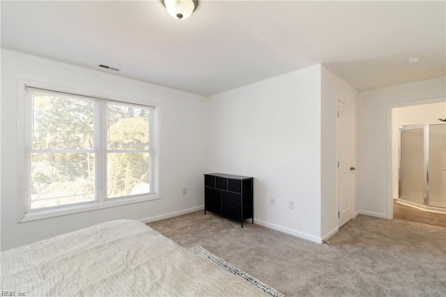 unfurnished bedroom featuring light carpet