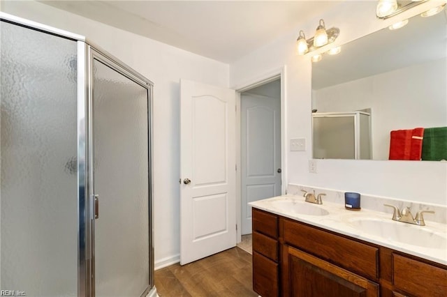 bathroom featuring vanity, hardwood / wood-style flooring, and walk in shower