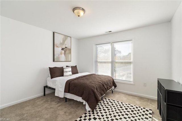 bedroom featuring light colored carpet