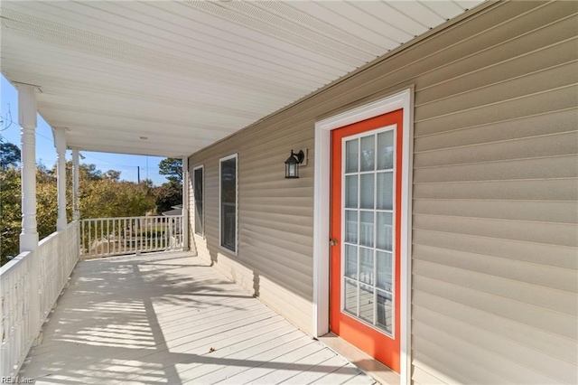 wooden terrace featuring covered porch