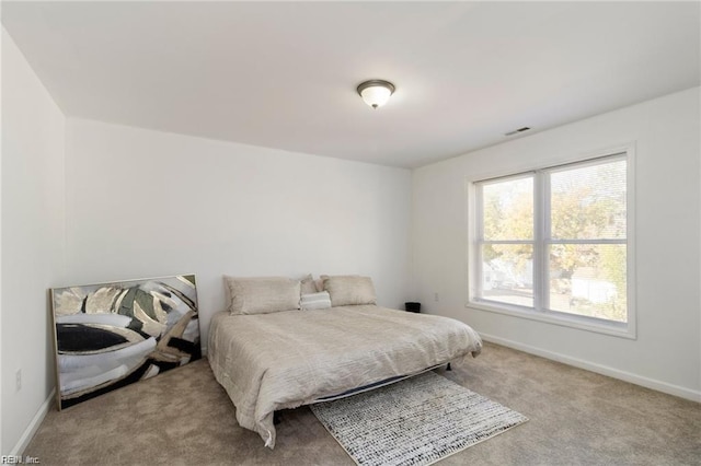 bedroom featuring light colored carpet