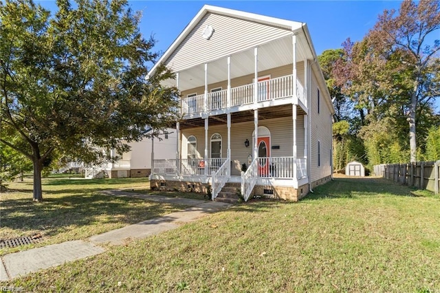 view of front of house with a front yard and a shed