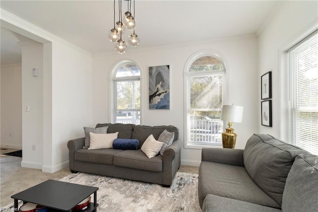 carpeted living room featuring crown molding and a chandelier