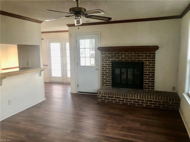 unfurnished living room with a fireplace, dark hardwood / wood-style floors, ceiling fan, and ornamental molding