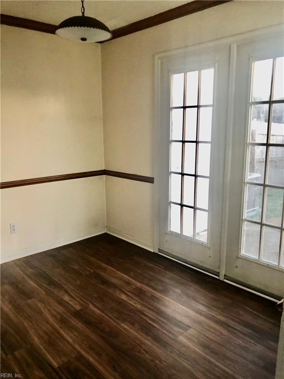 unfurnished room with dark hardwood / wood-style flooring