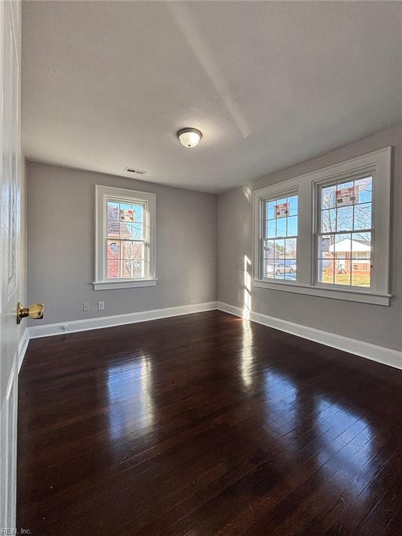 empty room with dark hardwood / wood-style floors