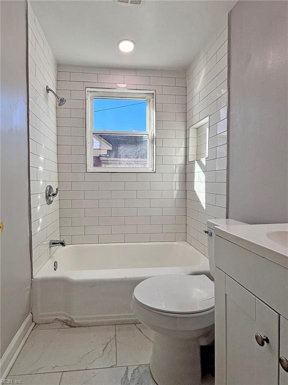 full bathroom with vanity, toilet, and tiled shower / bath