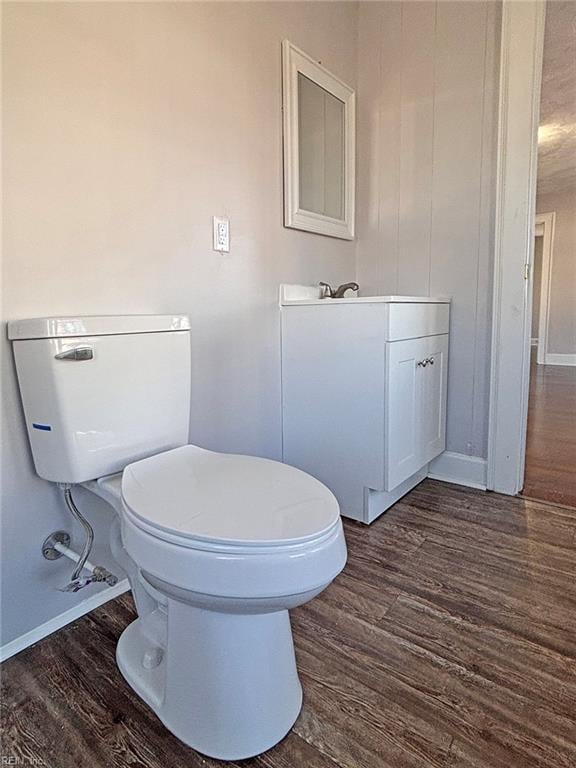 bathroom with vanity, hardwood / wood-style flooring, and toilet