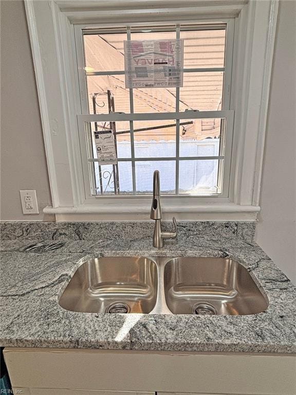 details with light stone countertops and sink