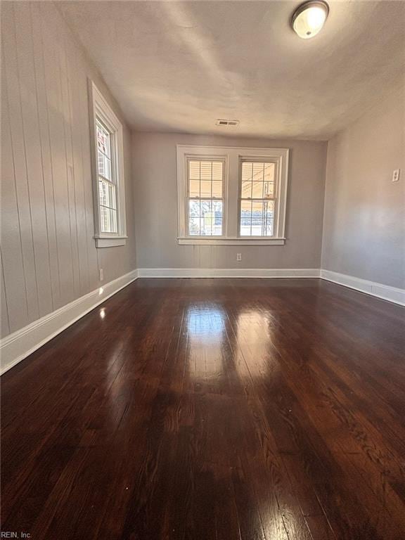 empty room featuring dark hardwood / wood-style flooring