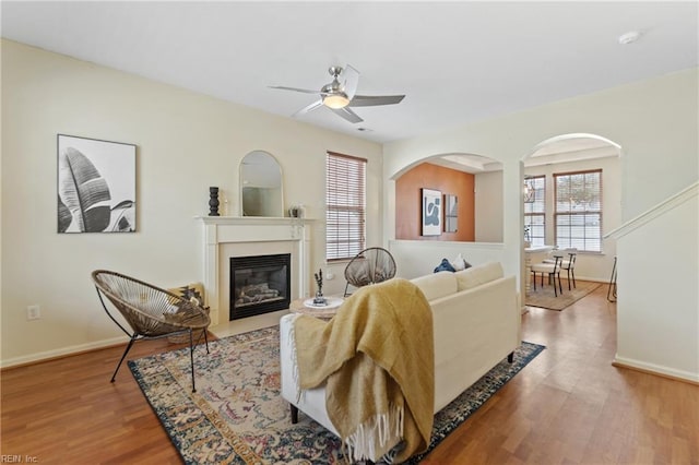 living room featuring wood-type flooring and ceiling fan