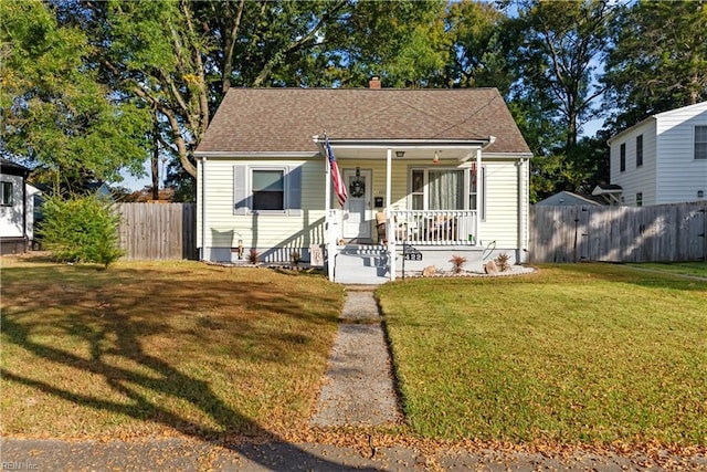 bungalow-style home featuring a front lawn and covered porch